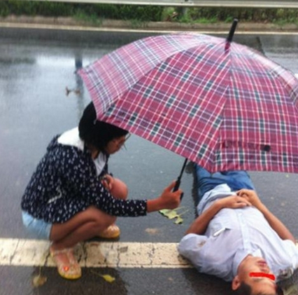滨海“眼镜妹”雨中为车祸伤者撑伞